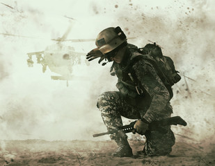 US soldier in the desert during the military operation turning to combat helicopter approaching...