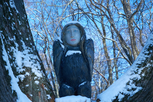 wooden sculpture of bird with woman's head