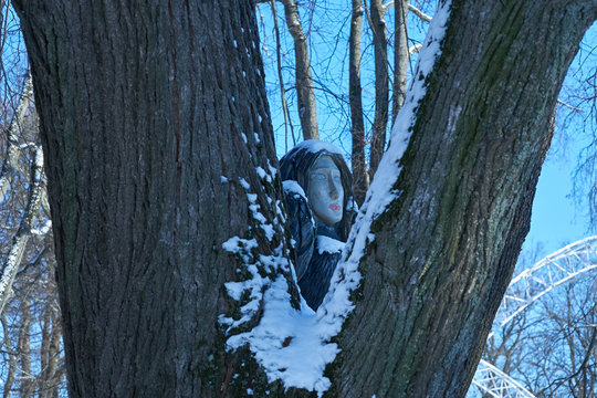 wooden sculpture of bird with woman's head