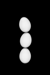 White eggs on a black background