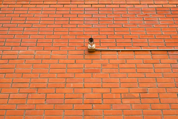 Security camera at the brick wall