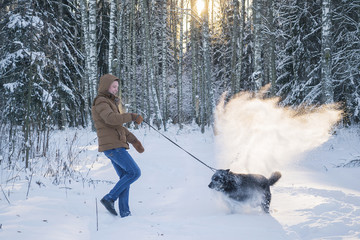 man with his dog in winter forest