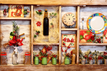 Details of the interior decoration of cafes, bars, room in shabby chic style. Bottle of wine, watches, plates, green banks, fork, post cards, viburnum, grater. Winter decor.