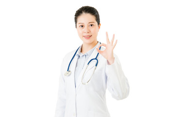Fototapeta premium Smiling asian woman doctor with stethoscope showing ok gesture
