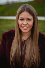 Pretty blonde girl with fur coat