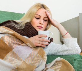 Woman sitting under plaid