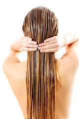 Woman applying hair conditioner. Isolated on white.