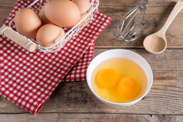 Egg yolk for cooking on white bowl. Selective focus.