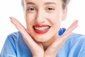Close up portrait of a woman with tooth braces on the white background