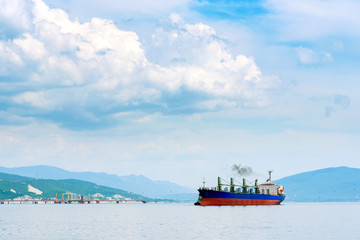 The ship enters the bay. Tanker in the port.