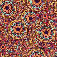 Ethnic seamless pattern with feathers and circles.
