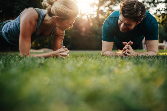 Healthy young couple exercising at park
