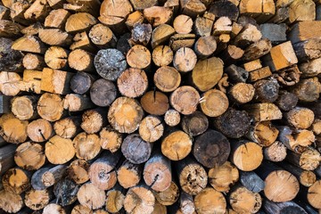 Fototapeta premium Chopped firewood, stacked woodfuel, fuelwood texture. Natural wooden background.