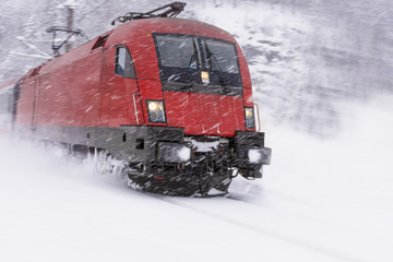 Fast Train in Heavy Snow Storm. Blizzard on Railway.