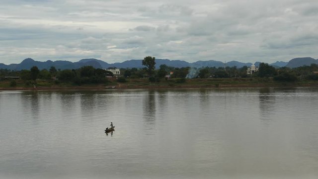 Fishermen boat floating on the majestic Mekong River.