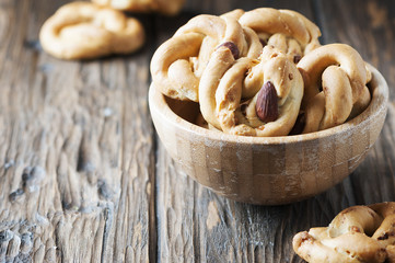 Traditional italian tarallo with almonds on the wooden table