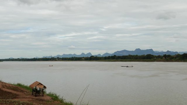 Fishermen boat floating on the majestic Mekong River.