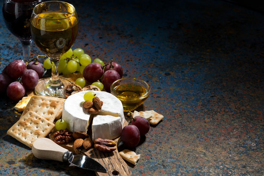 Camembert cheese, snacks and glasses of wine