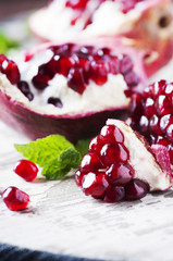 Red sweet pomegranate on the wooden table