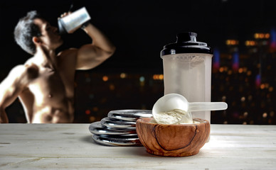 Protein shake Vanilla flavor accompanied by weights and sportsme