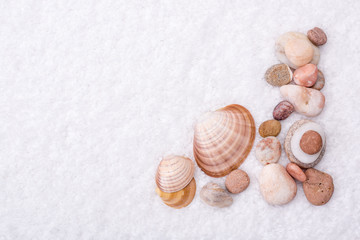 Border and frame. Spa border of natural stones and shell, on white towel background.