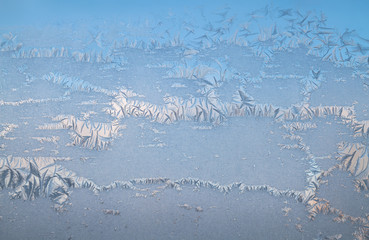 glittering frosty pattern on glass closeup