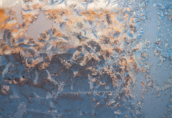 glittering frosty pattern on glass closeup