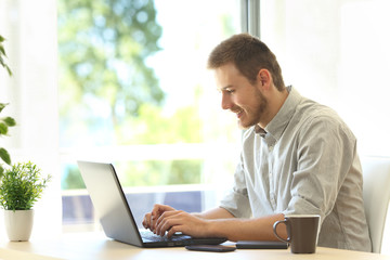 Writer writing with a laptop at home