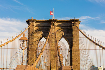 brooklyn bridge with united states flag on top