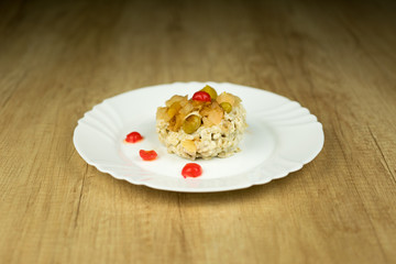 Sweet rice dish on plate on wooden table