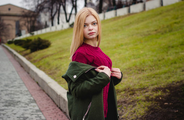 Girl on the street. Cool day. red sweater. Beautiful eyes.