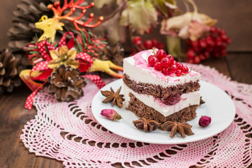 Cherry sponge cake with cream and red currant. Wooden background. Top view. Close-up