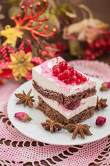 Cherry sponge cake with cream and red currant. Wooden background. Top view. Close-up