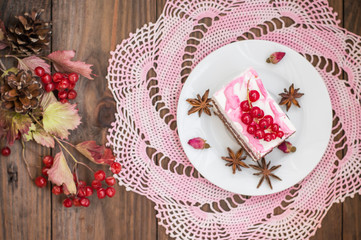 Cherry sponge cake with cream and red currant. Wooden background. Top view. Close-up