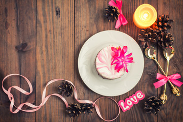 Cherry sponge cake with cream and red currant. Wooden background. Top view. Close-up