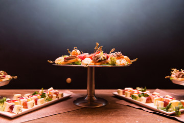 Canapes snacks with shrimps and bacon on dinner plate