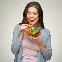 young smiling woman eating salad.