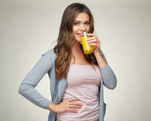 casual dressed woman drink orange juice with glass.