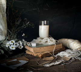 rustic breakfast. still life, vintage. the book chrysanthemums, the milk. black background. space for text