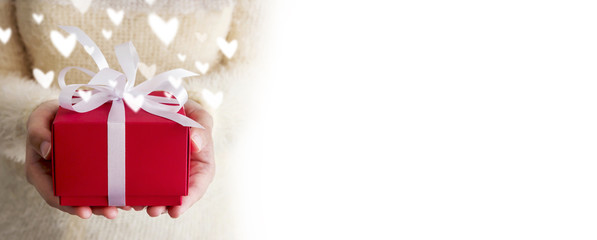 Valentines day concept of young woman hands holding red gift box