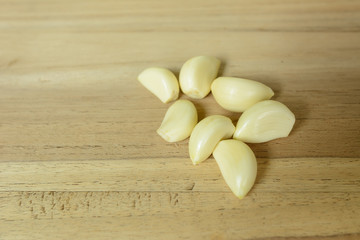 piece of garlic on wood cutting board prepare cooking