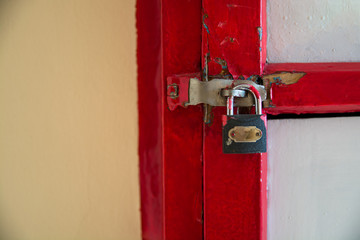 Part of red box with a latch and lock.