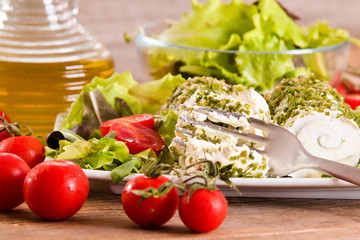 Goat cheese with salad and cherry tomatoes. 