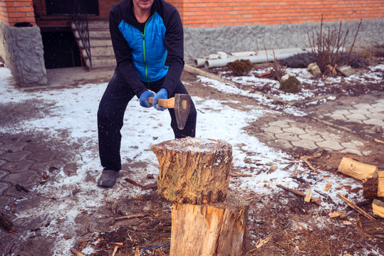 Sporty Man Chops Wood On The Farm