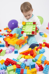 baby boy playing with building blocks