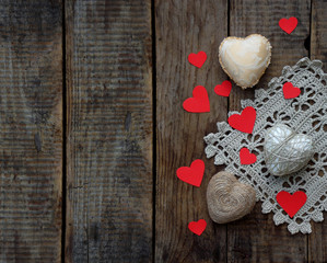 Valentine's Day concept. Composition of colourful handmade hearts on wooden background. Needlework. Selective focus