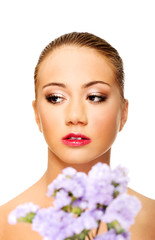 Fototapeta premium Sensual young spa woman holding flower.