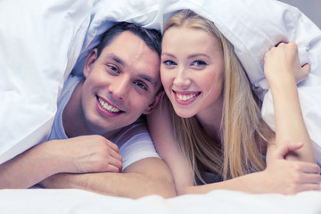 happy couple sleeping in bed