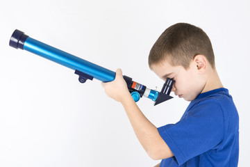 boy looking trough telescope