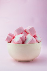 Pink heart-shaped marshmallows in with pink background